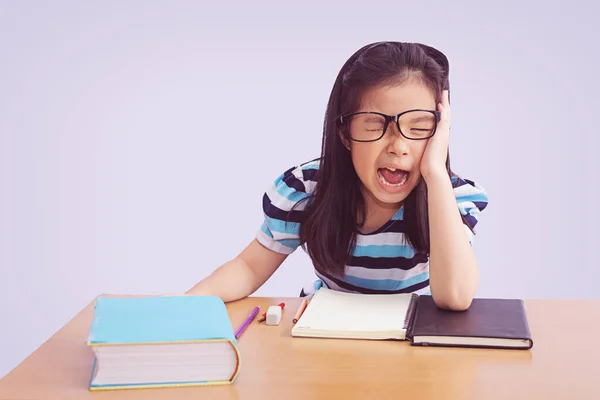 Bored and tired asian student girl doing homework, isolated on g — Stock Photo, Image