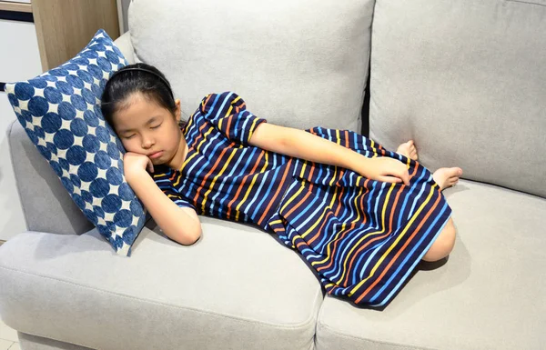 Little asian girl sleeps on a couch — Stock Photo, Image