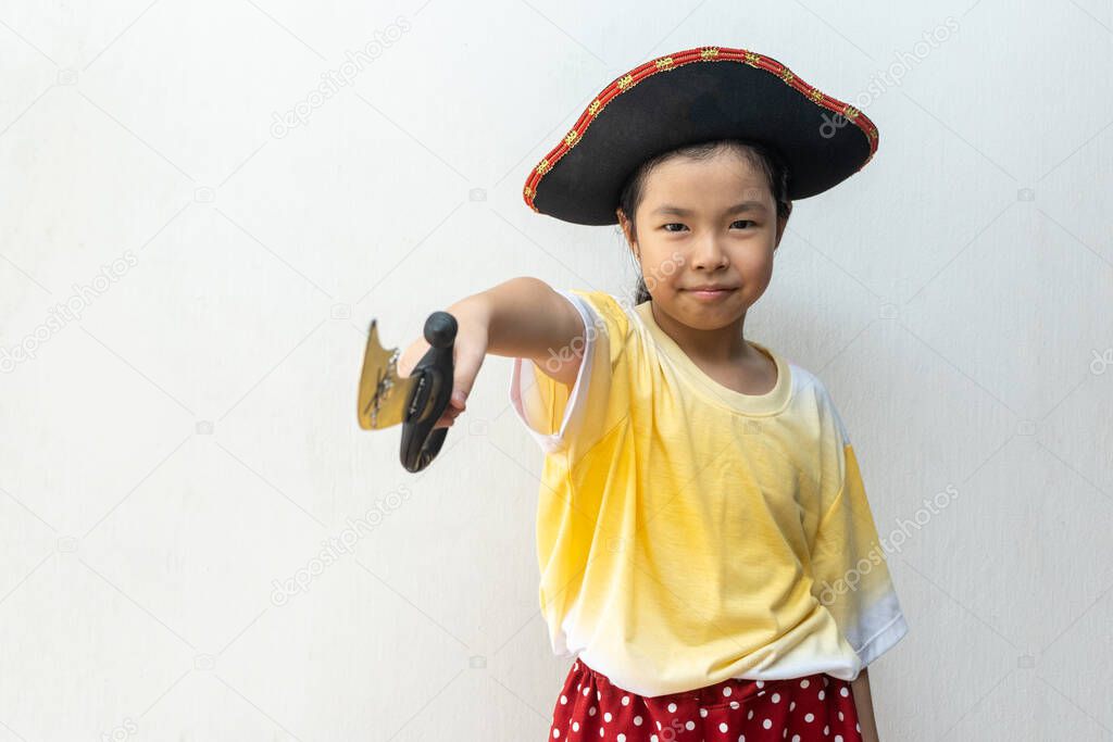 Asian girl smiling in pirate costume 