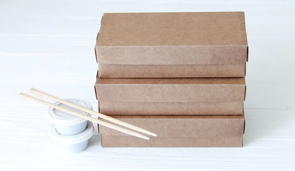 Sushi sets on eco biodegradable containers ready to take away on white wooden background