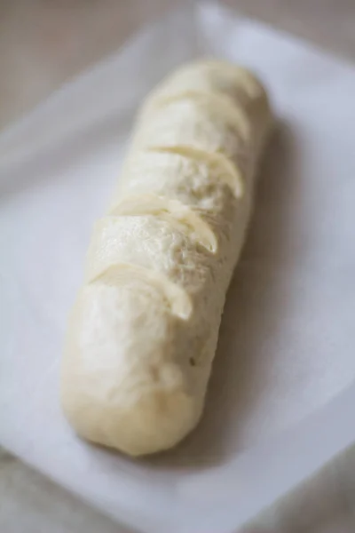Formed long loaf bread with scores before baking, yeast dough