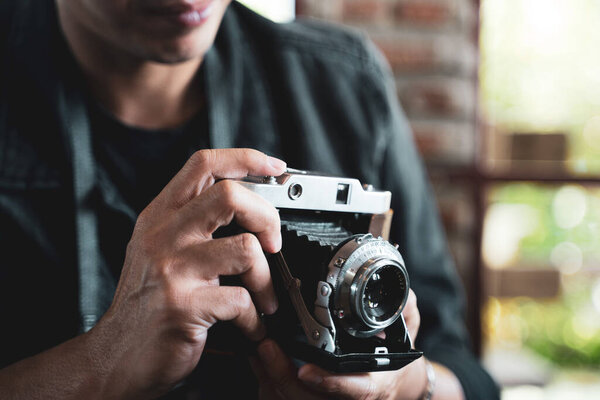a man holding the vintage old film camera