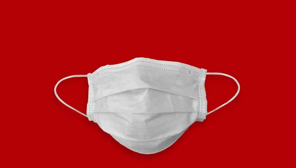 Medical mask for corona or covid-19 virus ,safety breathing masks for virus inflection,isolated on red background with long shadow, health protection concept,cover mouth to prevent virus,pollution