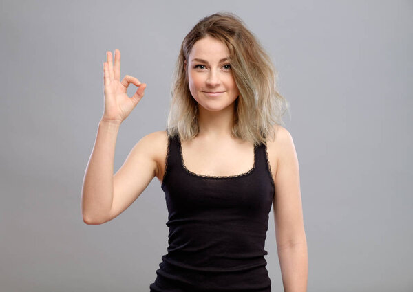 Cute girl showing ok sign
