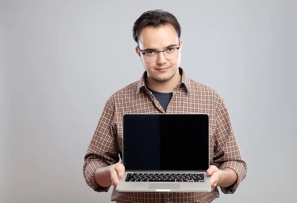 Hombre sosteniendo y mostrando ordenador portátil — Foto de Stock
