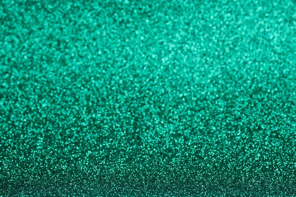 Defocused green glitter background