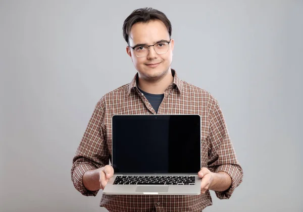 Человек держит и показывает ноутбук — стоковое фото