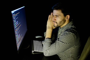 Yazılım geliştirici bilgisayarda karanlık ev ofis