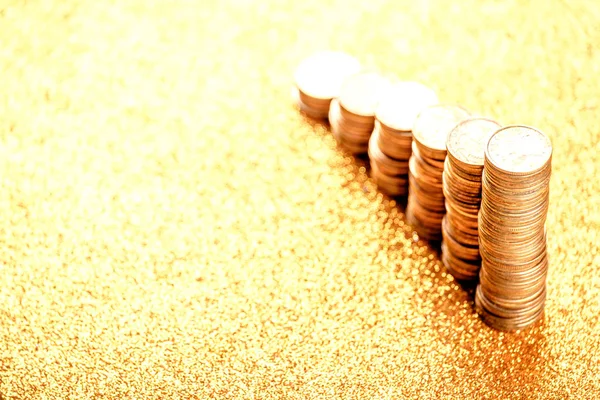 Stacks of copper coins on golden background