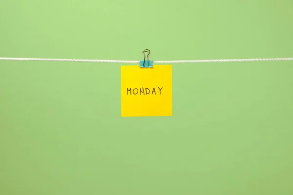 Yellow paper sheet on the string with text Monday — Stock Photo, Image