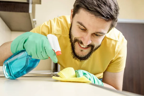 Male janitor cleaning kitchen with sponge — Stock Photo, Image