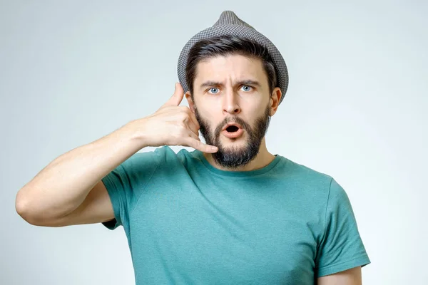 Handsome young man showing a call me sign — Stock Photo, Image