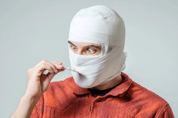 Sad injured bandaged man with pills — Stock Photo, Image