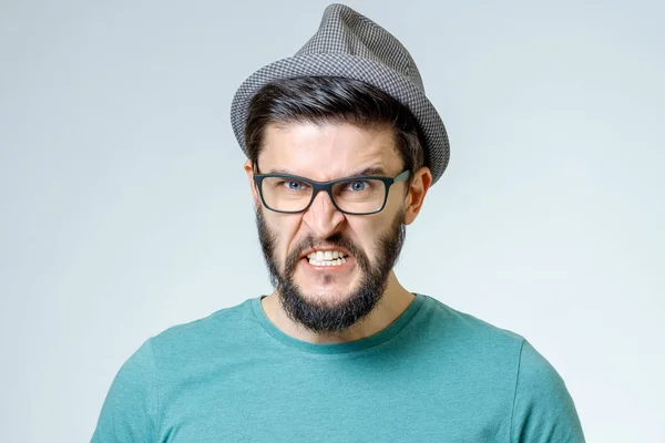 Angry and furious male on a gray background — Stock Photo, Image