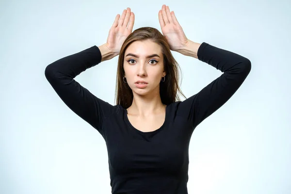 Woman showing horns with her fingers — Stock Photo, Image