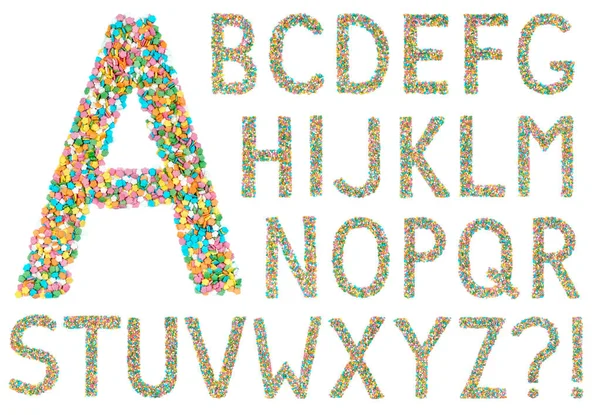 English alphabet letters and symbols made of little candies — Stock Photo, Image