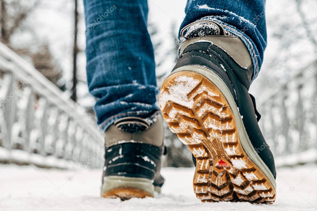Walking in the snow. Closeup of winter shoes