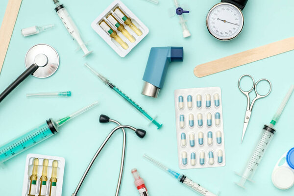 Flat lay of medical tools on colored background