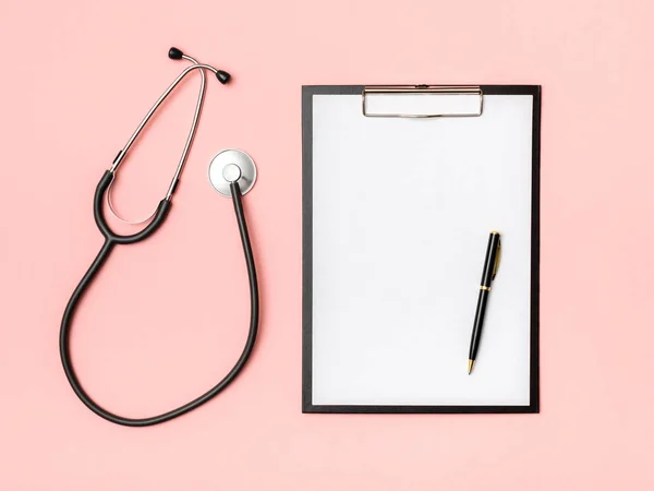 Workplace of doctor with notebook and stethoscope