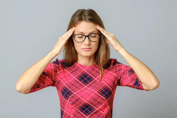 Young woman with a headache touching head — Stock Photo, Image