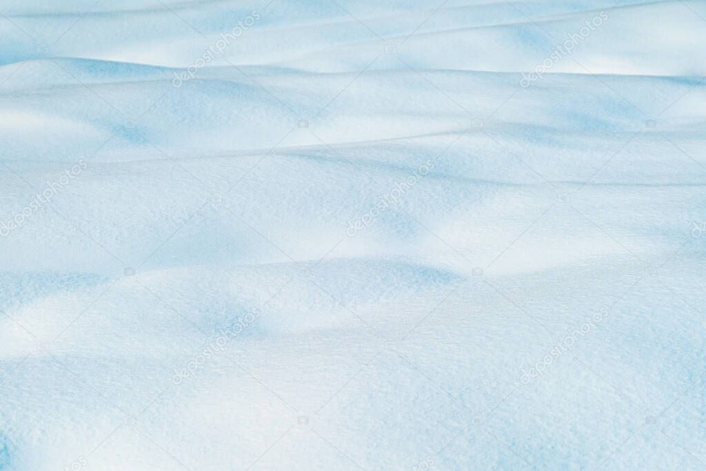 White and blue snowy texture of natural snow surface