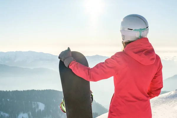 女性滑雪者站在雪板上欣赏高山风景的背景 滑板概念 — 图库照片