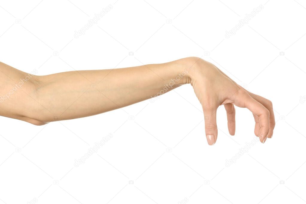 Hand picking, holding, grabbing or reaching. Woman hand with french manicure gesturing isolated on white background. Part of series