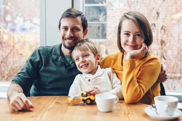 happy family sitting in restaurant