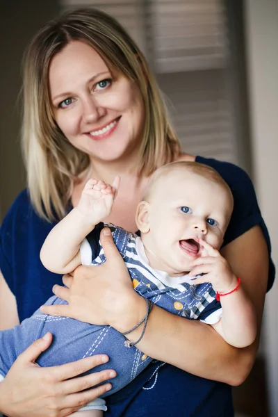 Smiling mother hugging baby boy — Stock Photo, Image