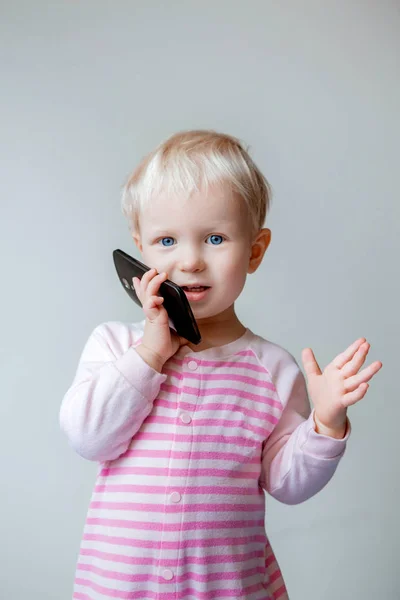 Blond baby girl with phone — Stock Photo, Image