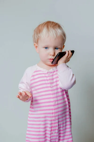 Blond baby girl with phone — Stock Photo, Image