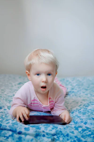 Blond baby girl with tablet — Stock Photo, Image