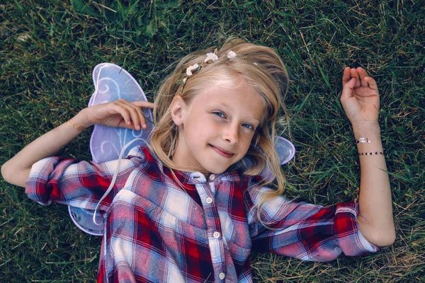Smiling girl wearing fairy wings