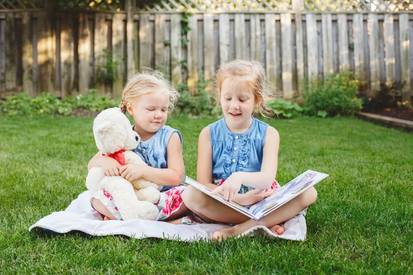 Niños amigos sentados con libro — Foto de Stock