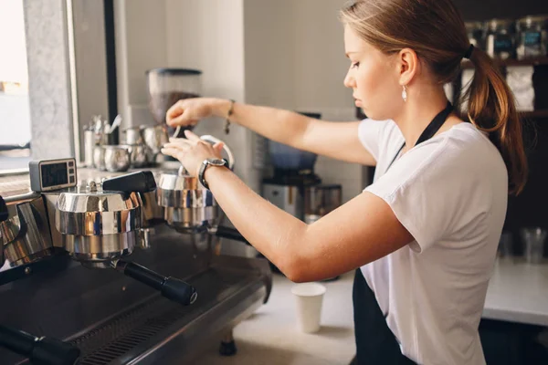 Barista holding milk jug