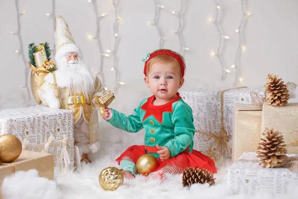 Portrait of blonde Caucasian baby girl with blue eyes in elf costume celebrating Christmas or New Year holiday — Stock Photo, Image