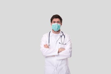 Tıbbi maske takan doktor ellerini çapraz yaptı..