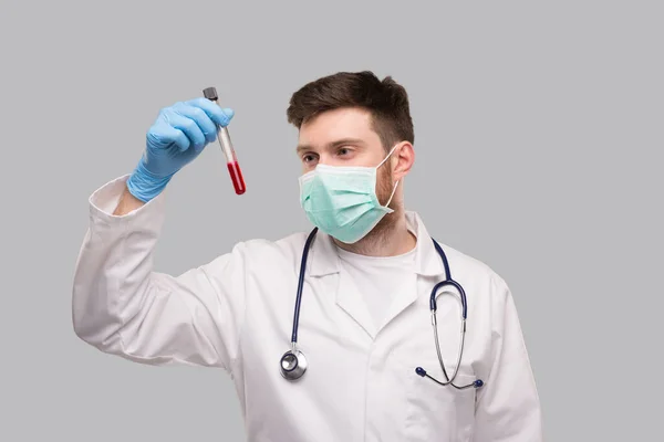 Mannelijke dokter checkt bloedanalyse draagt medische maskers en handschoenen. Portret — Stockfoto