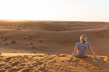 Sarışın kız Wahiba Sands, Umman gün batımında rahatlatır