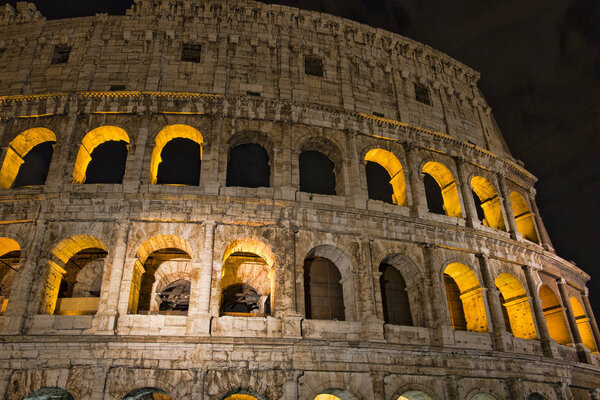 Colosseum at night- the main tourist attractions of Rome, Italy. Ancient Rome Ruins of Roman Civilization.