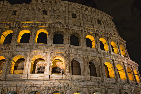 Colosseum at night- the main tourist attractions of Rome, Italy. Ancient Rome Ruins of Roman Civilization