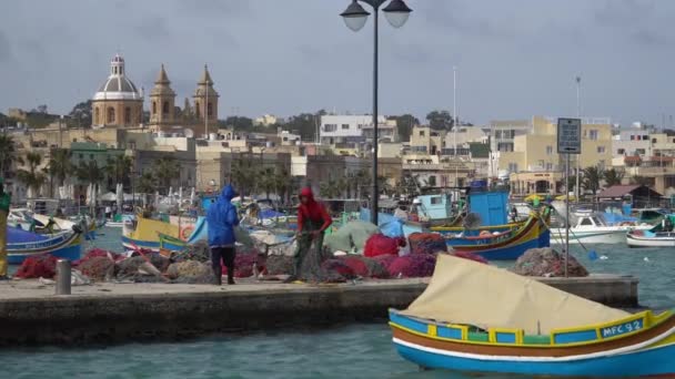 Marsachlokk - Malta, Nisan, 2018: Balıkçı köyü Marsachlokk Malta'da limanda renkli Malta tekne. — Stok video