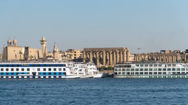 Luxor, Egypt - January 2020: Nile embankment with boats and Luxor Temple in Luxor, beautiful landscape, Egypt