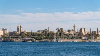 Luxor, Egypt - January 2020: Nile embankment with boats and Luxor Temple in Luxor, beautiful landscape, Egypt