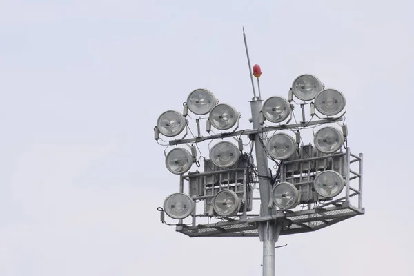 Cricket stadium floodlights at day with blue sky, High power spotlights, grandstand and outdoor Cricket pitches in the evening in Delhi India