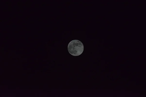 Nature background. Attractive photo of night sky with cloudy and bright super moon, Full moon shining on the sky in cloudy day