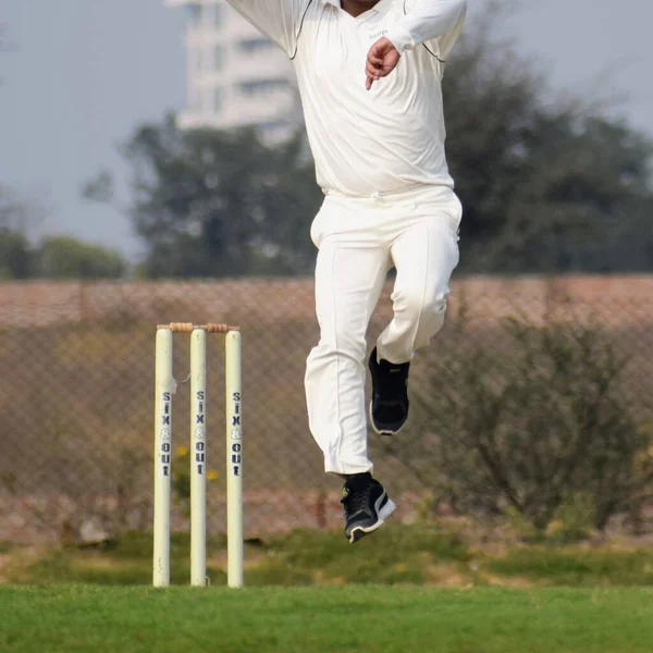 Full length of cricketer playing on field during sunny day, Cricketer on the field in action, Players playing cricket match at field