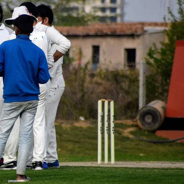 Full length of cricketer playing on field during sunny day, Cricketer on the field in action, Players playing cricket match at field