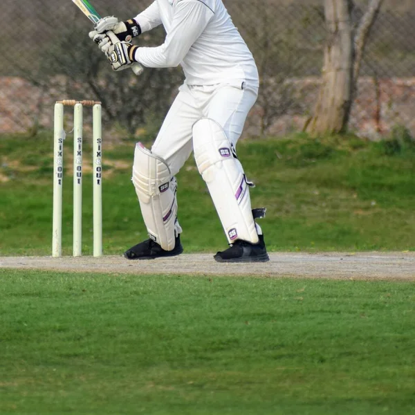 Full length of cricketer playing on field during sunny day, Cricketer on the field in action, Players playing cricket match at field