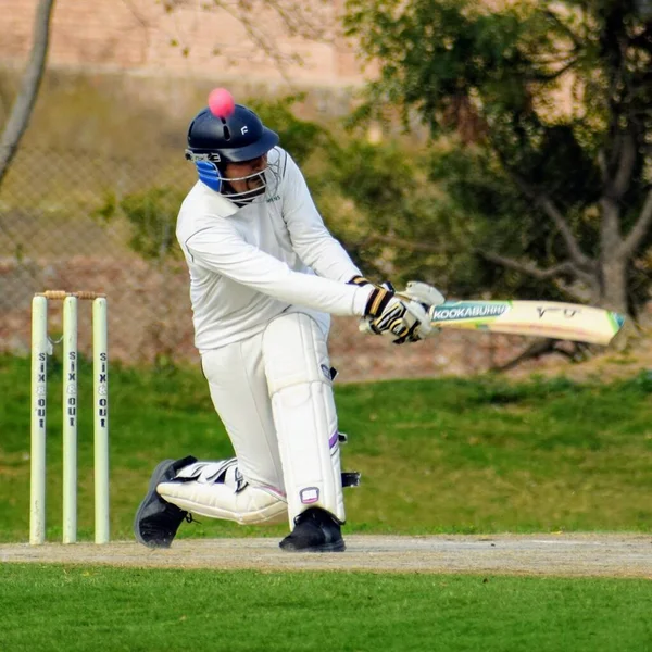 Full length of cricketer playing on field during sunny day, Cricketer on the field in action, Players playing cricket match at field